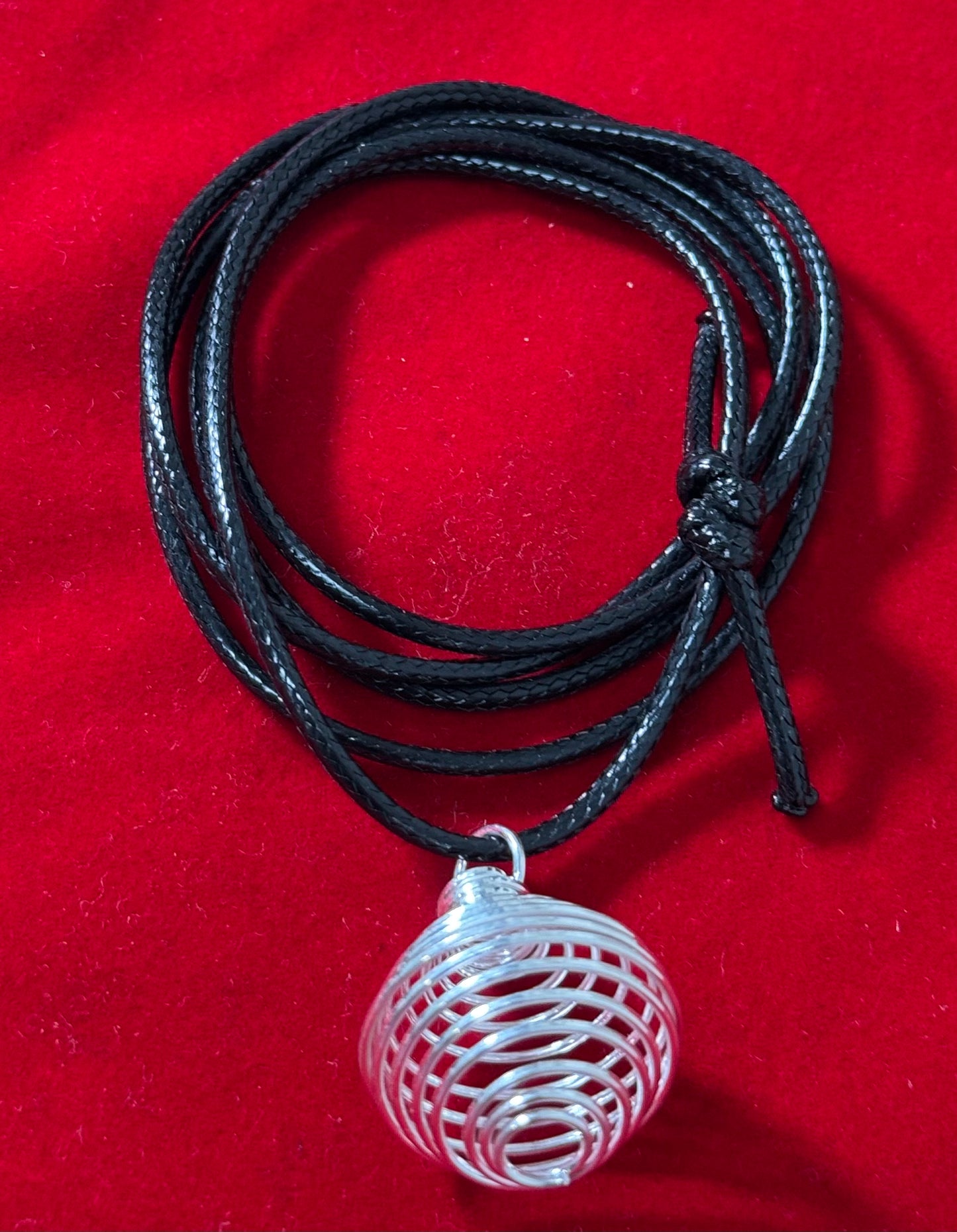 Silver Plated Round Cage with Black Cord – elegant round cage pendant plated in silver, hanging on a black cord necklace.