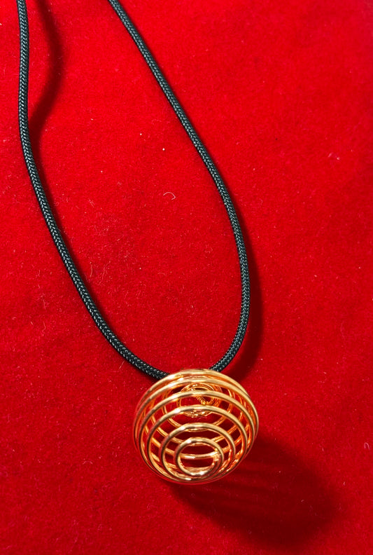 Copper Plated Round Cage with Black Cord – elegant round cage pendant with copper plating, hanging on a black cord necklace.
