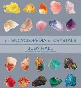 Cover of Encyclopedia of Crystals by Judy Hall, featuring an extensive guide to crystals, their metaphysical properties, and healing applications.