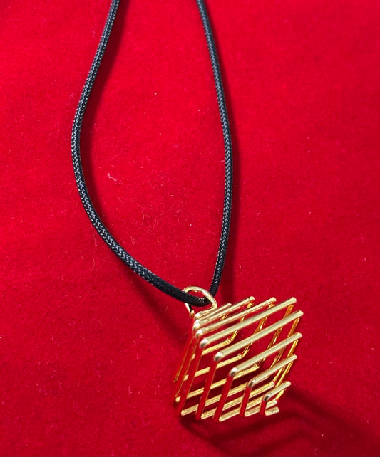 Gold Plated Square Cage with Black Cord – stylish square cage pendant with gold plating, hanging on a black cord necklace.
