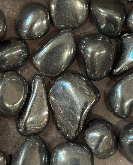 Hematite Tumbled Crystal – polished hematite stones known for grounding and protective energy.
