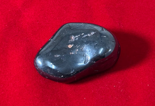 Hematite Tumbled Crystal – polished hematite stones known for grounding and protective energy.
