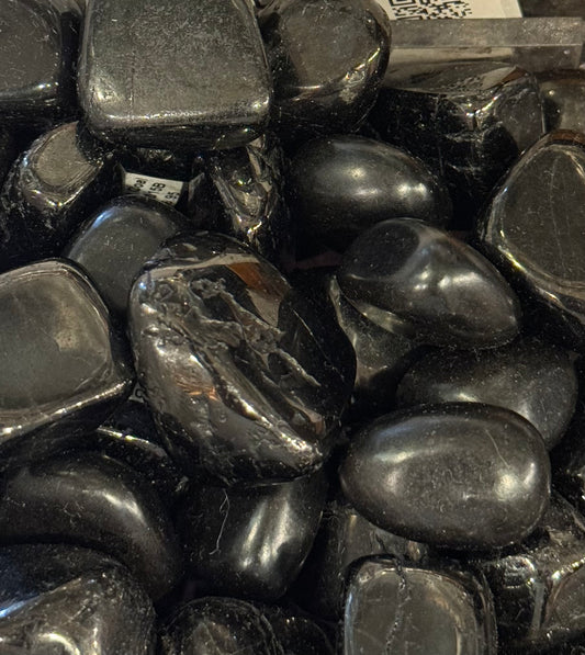 Jet Coal Tumbled Crystal – polished jet coal stones known for protection and purification.
