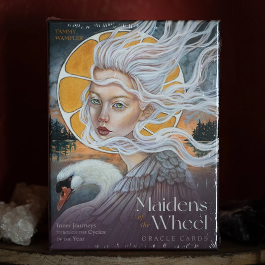 Maidens of the Wheel Oracle Cards by Tammy Wampler – 45-card deck featuring goddess archetypes and elemental beings, accompanied by a 120-page guidebook for seasonal and cyclical guidance.
