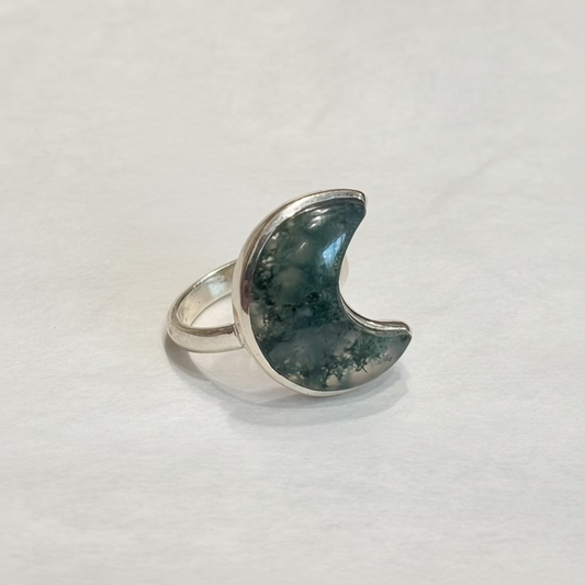 Moss Agate Moon Shaped Sterling Silver Ring size 6 – unique crescent design featuring earthy green crystal known for growth and healing.

