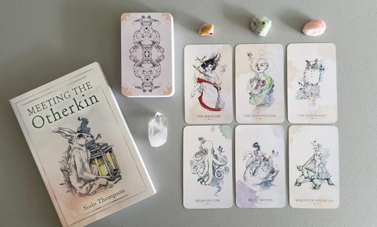Otherkin Tarot by Siolo Thompson – a 78-card deck featuring whimsical, anthropomorphic beings painted with natural pigments on unbleached handmade paper, based on the Rider-Waite-Smith system.
