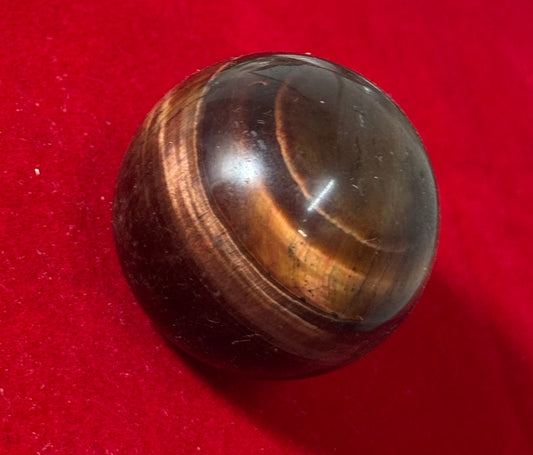 Red Tigers Eye Sphere Shaped Crystal – polished red tiger's eye crystal shaped into a sphere, ideal for grounding and energy enhancement.
