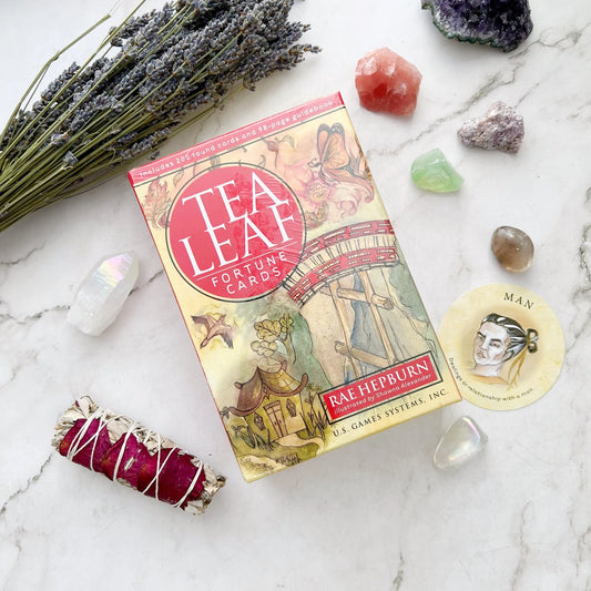 Tea Leaf Fortune Cards by Rae Hepburn – 200 round divination cards featuring traditional tea leaf symbols, accompanied by a 98-page illustrated guidebook for tasseomancy.

