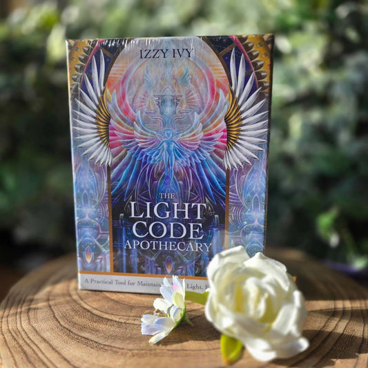 The Light Code Apothecary by Izzy Ivy – A 70-card oracle deck and 336-page guidebook offering elemental tools for spiritual ascension, including energy clearings, embodiment exercises, and shadow integration.
