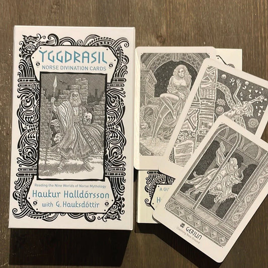 Yggdrasil: Norse Divination Cards by Haukur Halldórsson & G. Hauksdóttir – 81-card deck featuring intricate pen and ink illustrations of Norse mythology, accompanied by a 216-page guidebook for spiritual guidance and connection with the Nordic pantheon.
